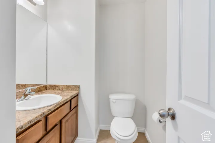 Vanity with an integrated sink and chrome faucet, set against a full-width mirror