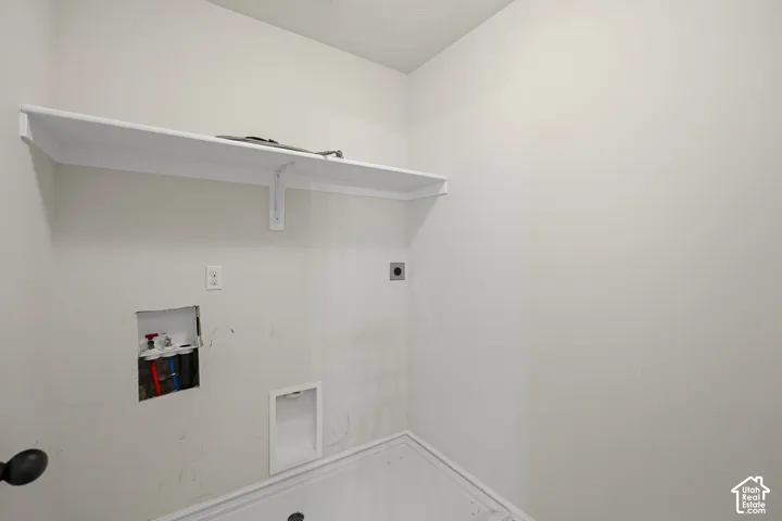 Built-in shelf, appliance hookups, and light-toned walls