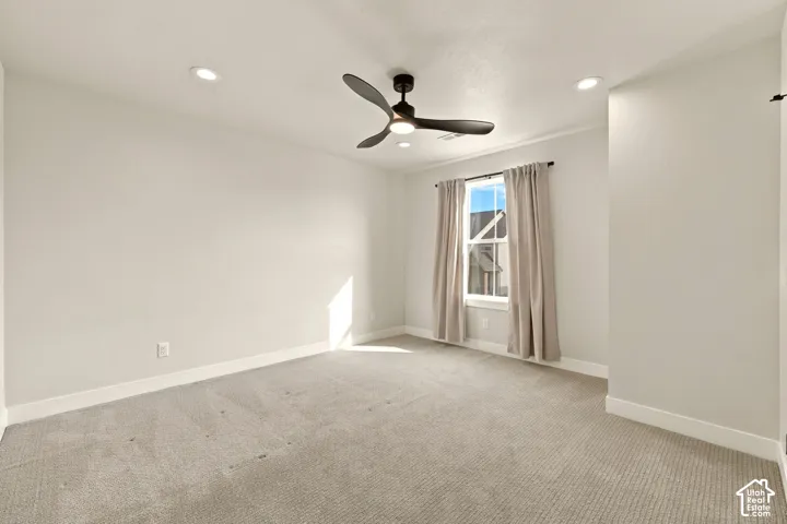 Recessed lighting, ceiling fan with integrated lighting, carpeted flooring, window with trim, and crown molding