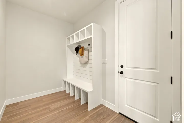 Built-in mudroom bench with cubby storage, upper cubbies, and coat hooks