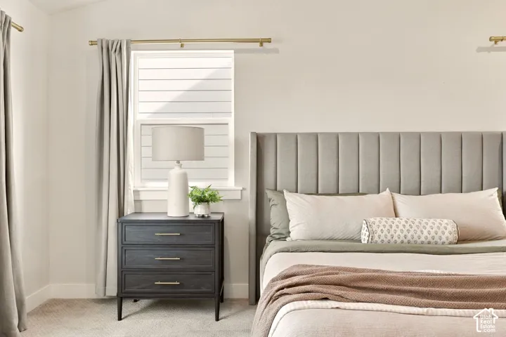 Upholstered channel-tufted headboard with a window, window blinds, and drapes