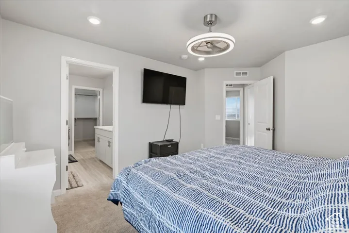 Recessed lighting, ceiling fan with integrated light, and carpet flooring