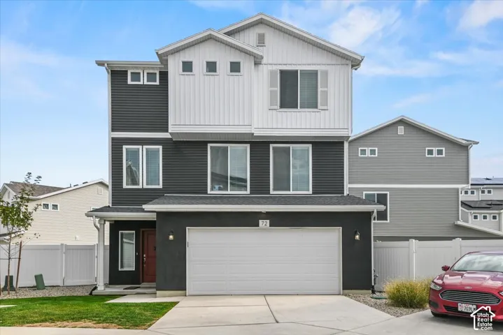 Contemporary multi-story exterior with dark siding and white accents