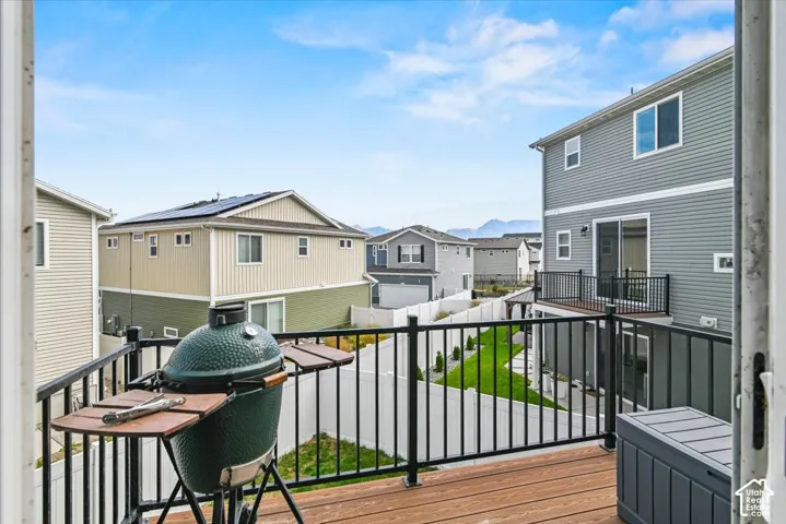 Outdoor deck featuring wood-finish flooring and black metal railings