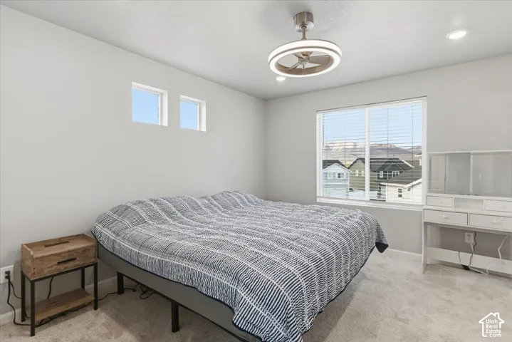 Carpeted flooring, recessed lighting, and a modern ceiling fan with integrated lighting