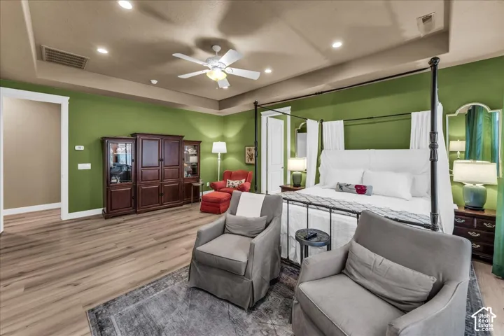 Wood-finish flooring, recessed lighting, and a ceiling fan create a comfortable atmosphere