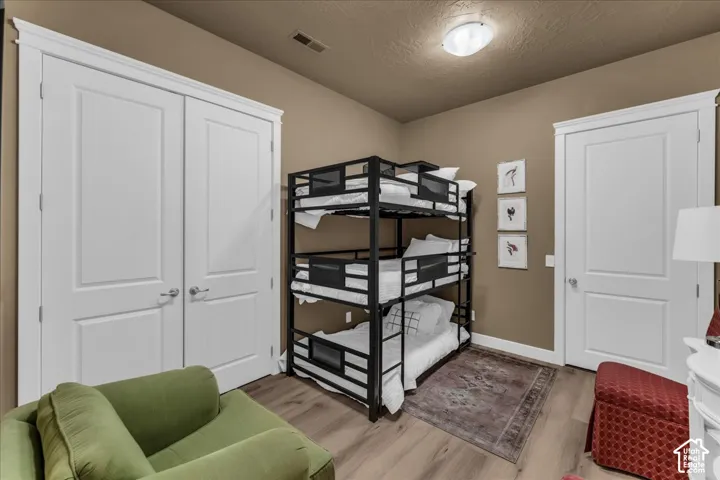 Wood-finish flooring with a neutral wall color, complemented by white trim and doors