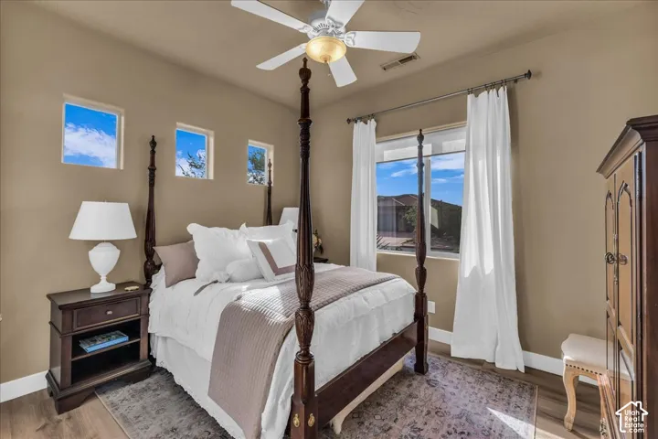 Wood-finish flooring, recessed lighting, and a ceiling fan with integrated lighting