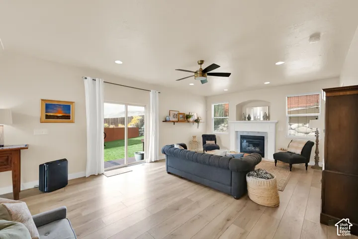 Open-concept living space featuring wood-finish flooring, recessed lighting, and a ceiling fan