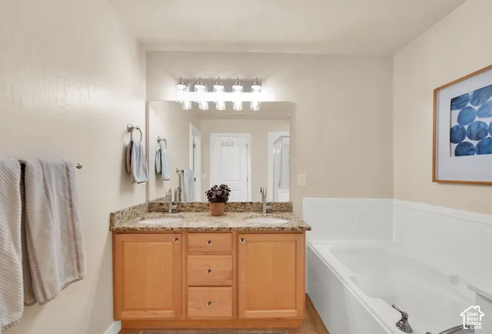 Double vanity with granite-style countertop, dual undermount sinks, and chrome fixtures