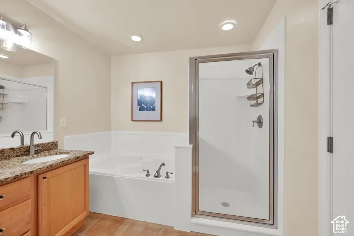 Dual vanity with a stone-finish countertop, undermount sinks, and chrome faucets
