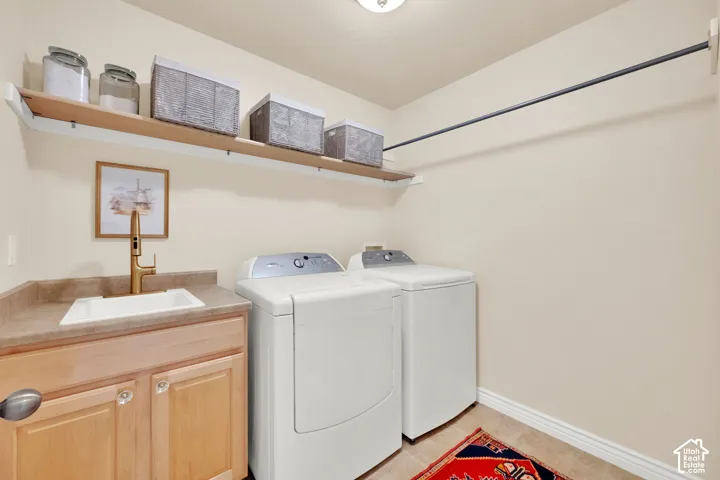 Built-in cabinetry, countertop, and sink with a contemporary gold-finish faucet