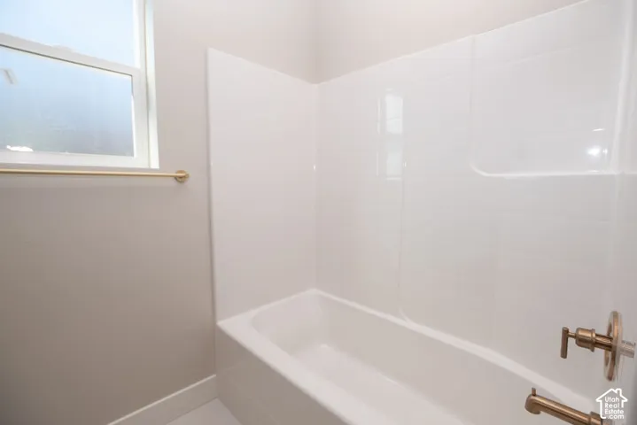 Bathtub with a white surround and bronze-finish fixtures