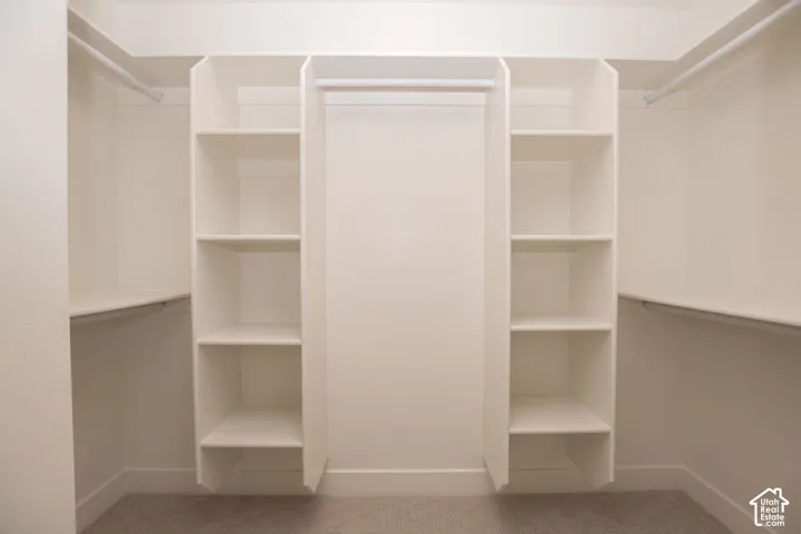 Integrated closet system featuring multiple hanging rods and built-in shelving units
