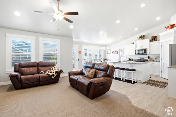 Open-concept living area featuring a vaulted ceiling and recessed lighting