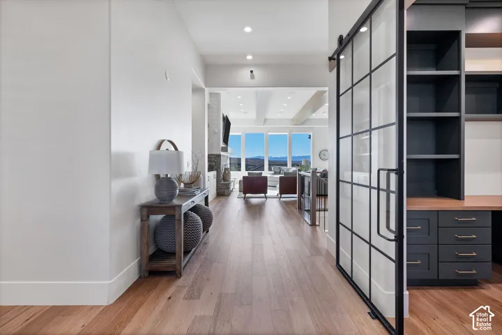 Wood-finish flooring throughout, with a barn door featuring a grid design