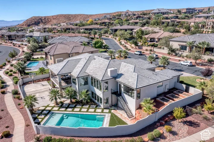 Exterior with a multi-level design, a swimming pool, and a sports court