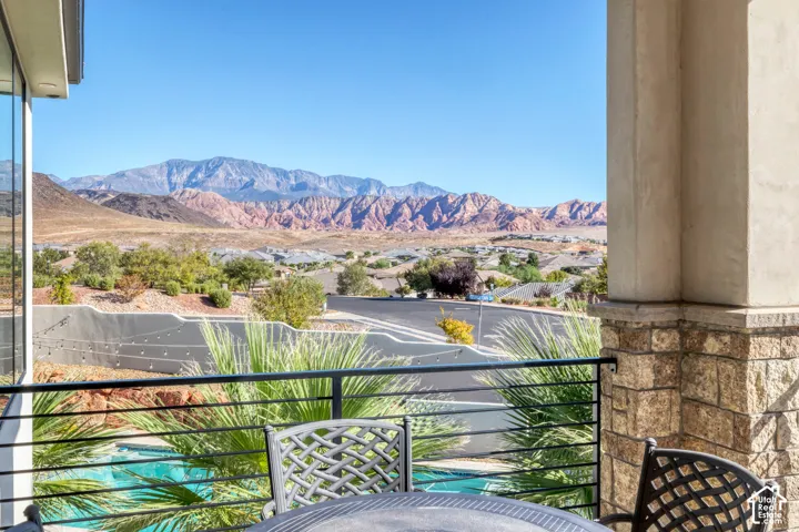 Expansive mountain scenery, distant red rock formations, and clear blue skies