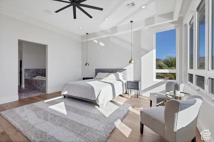 White walls, wood-finish flooring, and recessed lighting