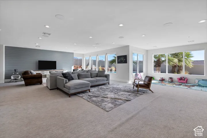 Spacious room with recessed lighting and large windows
