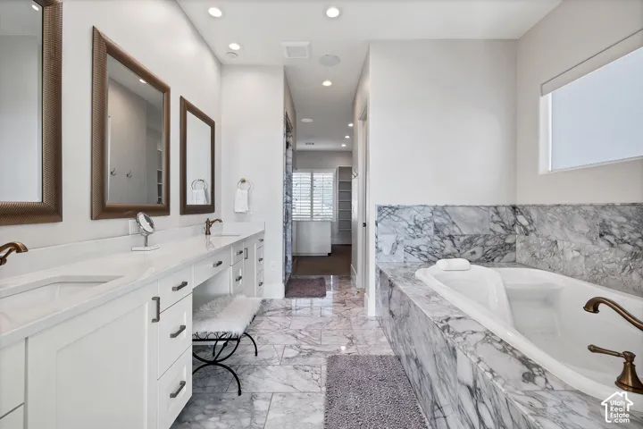 Dual vanity with undermount sinks and bronze-finish faucets