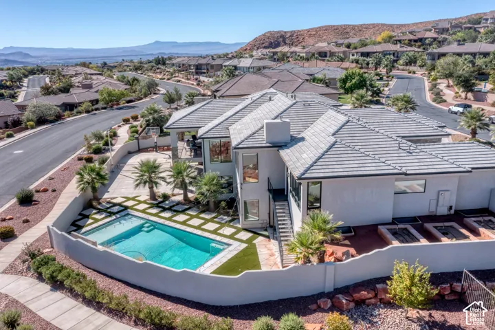Multi-level exterior with a tiled roof and stucco finish