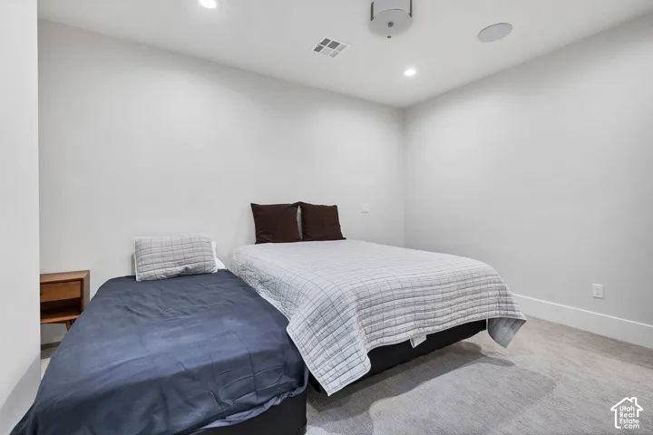 Versatile secondary bedroom featuring neutral walls, recessed ceiling lighting, and finished flooring throughout