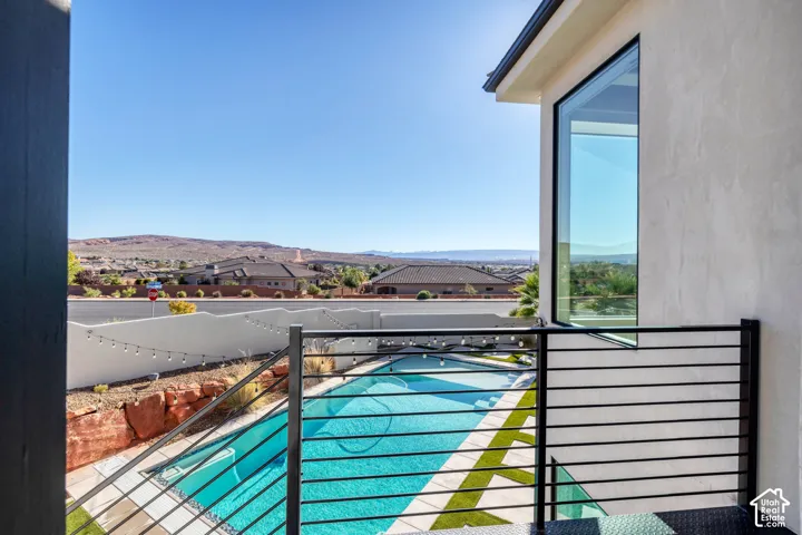 Angled window detail, horizontal bar railing, geometric pool design, artificial turf accents, and desert landscaping