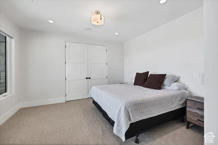 Recessed lighting, flush-mount ceiling fixture, and dual panel doors with dark hardware