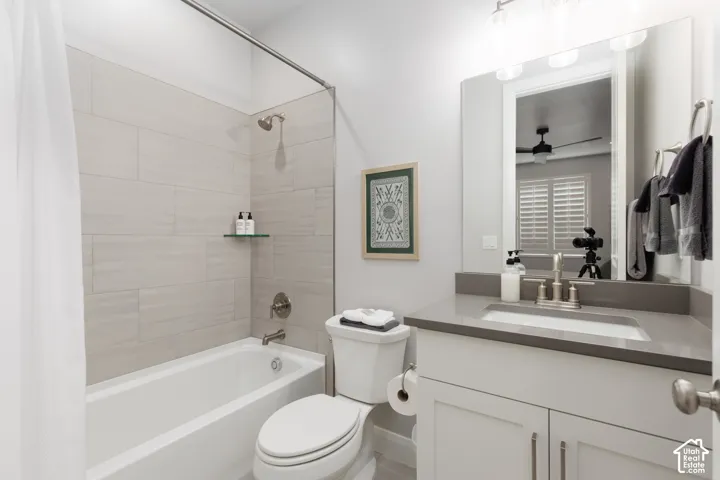 White vanity with sleek hardware, undermount sink, and a gray countertop
