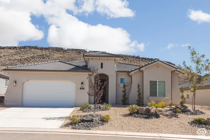 Contemporary stucco exterior with a tiled roof