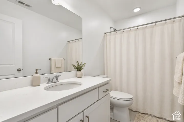 Integrated vanity with an undermount sink, a chrome faucet, and a large mirror