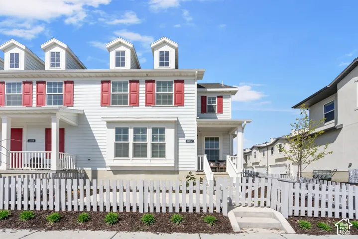 White clapboard siding with red decorative shutters