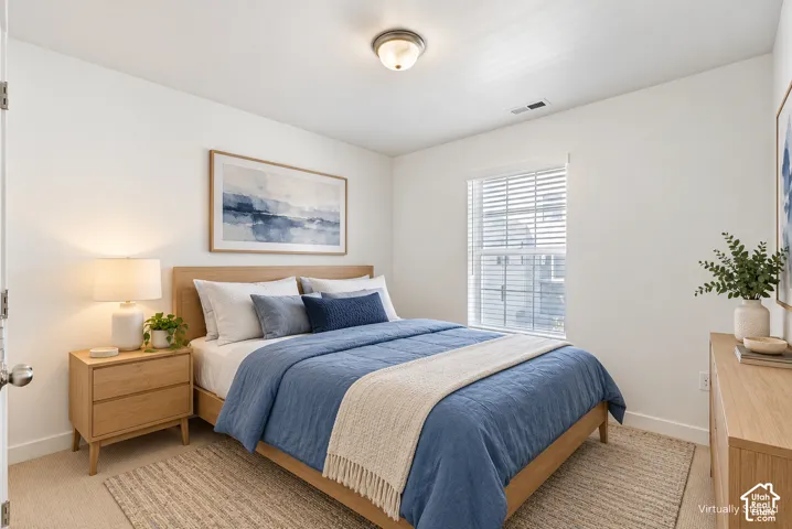 Recessed lighting, wood-finish flooring, and a large window with blinds