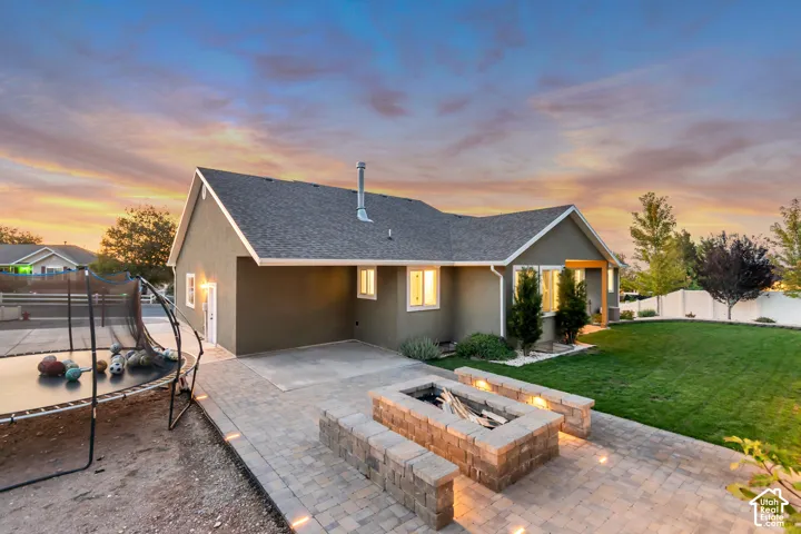 Expansive paver patio with built-in stone fire pit