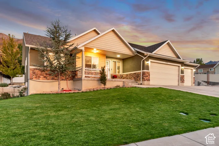 Expansive front lawn, multi-tone stone fa