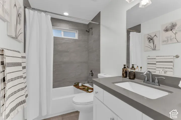 White vanity with a rectangular undermount sink, a gray countertop, and a chrome faucet
