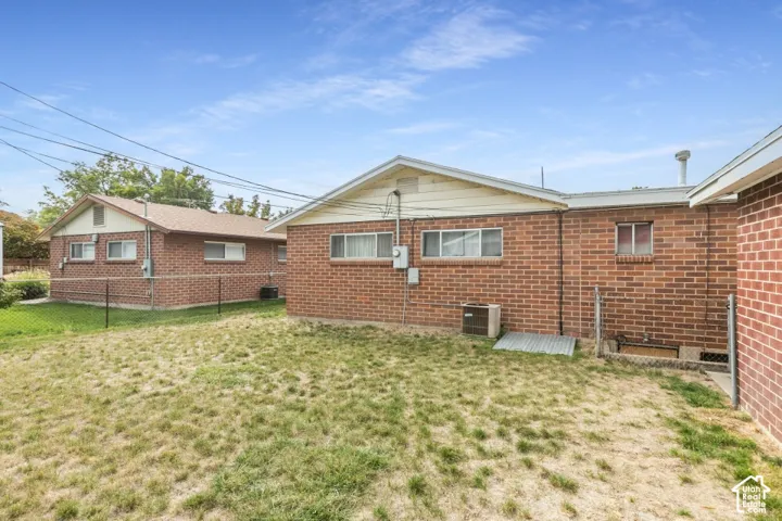 Brick exterior construction, multiple windows, and a chain-link fence