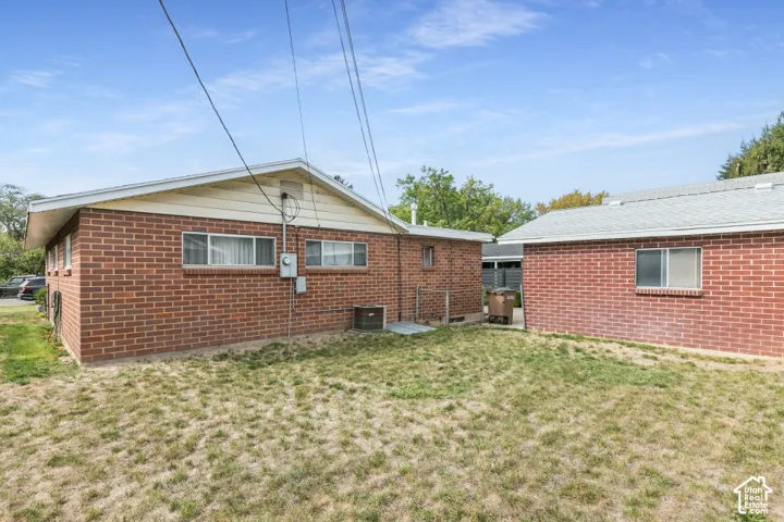 Brick exterior construction featuring multiple windows and a detached auxiliary building