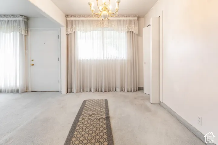 Spacious interior with neutral wall finishes and plush carpeting