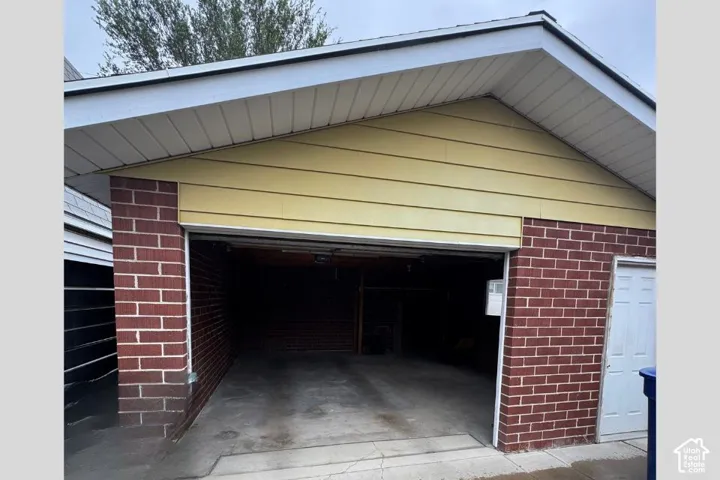 Attached garage with brick and horizontal siding exterior