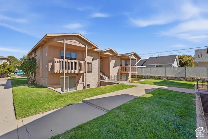 Rear community view showing the condo's upper-level balcony.