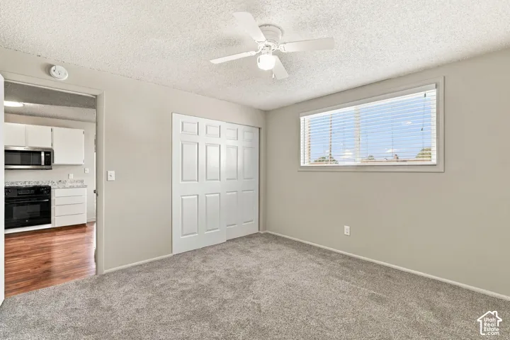 Bedroom #1 with a ceiling fan, a window with blinds, and bi-fold closet doors