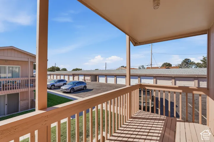 Covered balcony with wood railing and decking
