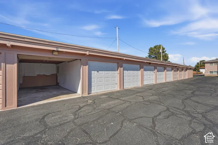 Row of individual garage units with light-colored overhead doors