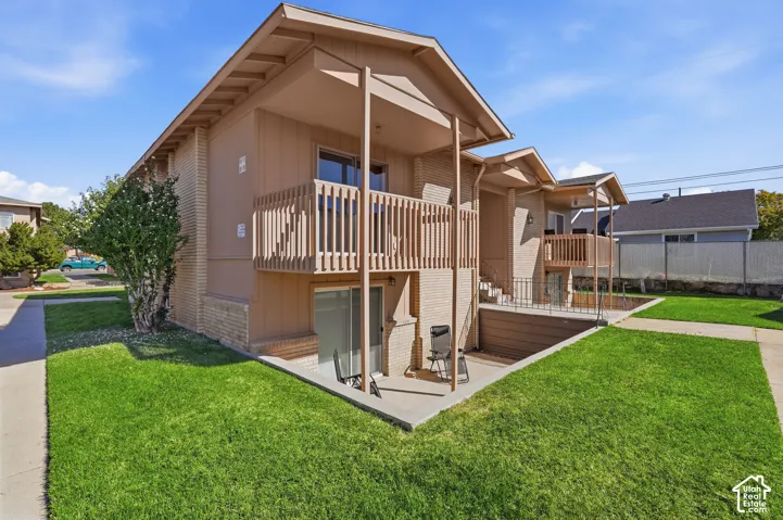 Marianne Condominiums exterior with private upper-level balcony and landscaped grounds.