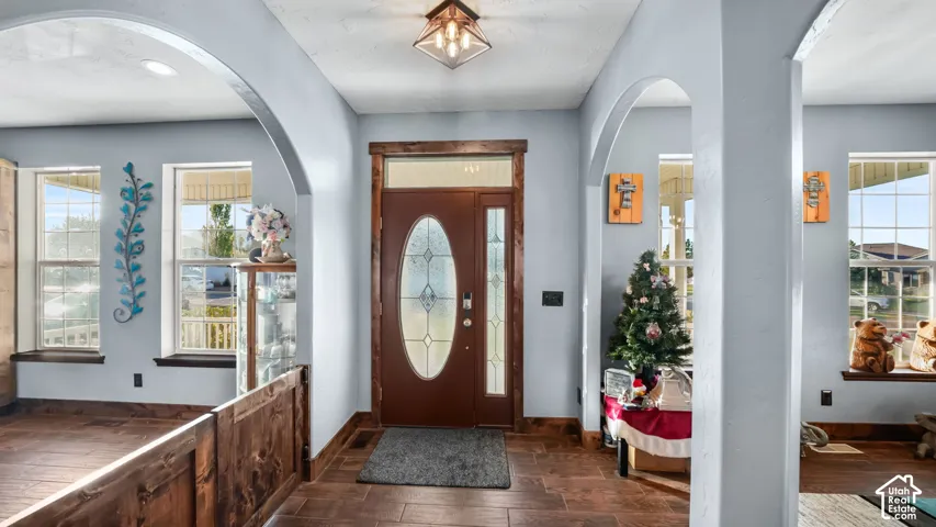 Entryway featuring a wood-panel door with leaded glass, recessed lighting, and tile flooring