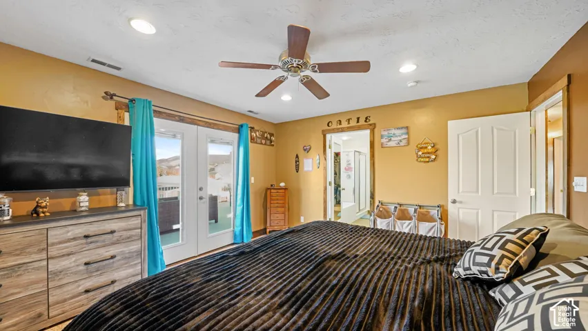 French doors opening to an exterior space, wood-finish flooring, ceiling fan, recessed lighting, and a white interior door
