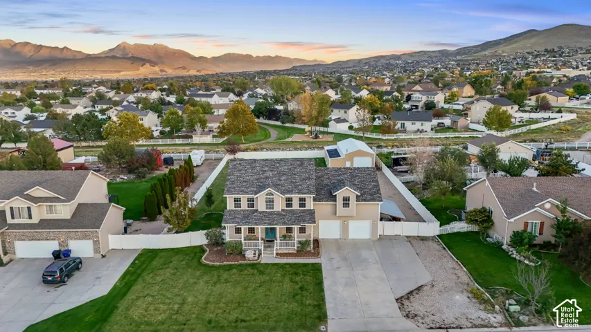 Two-story residence with a covered front porch, dormer windows, and a two-car garage