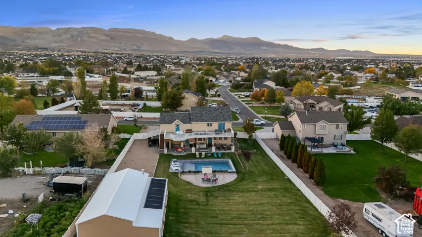 Expansive grounds featuring a swimming pool, detached garage, and a large grassy area